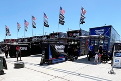 Team trucks lineup in the garage area.