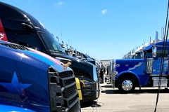 Team trucks face off in the garage area.