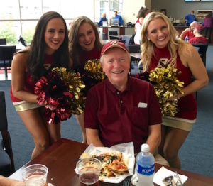 BC cheerleaders surround Tom Sugrue